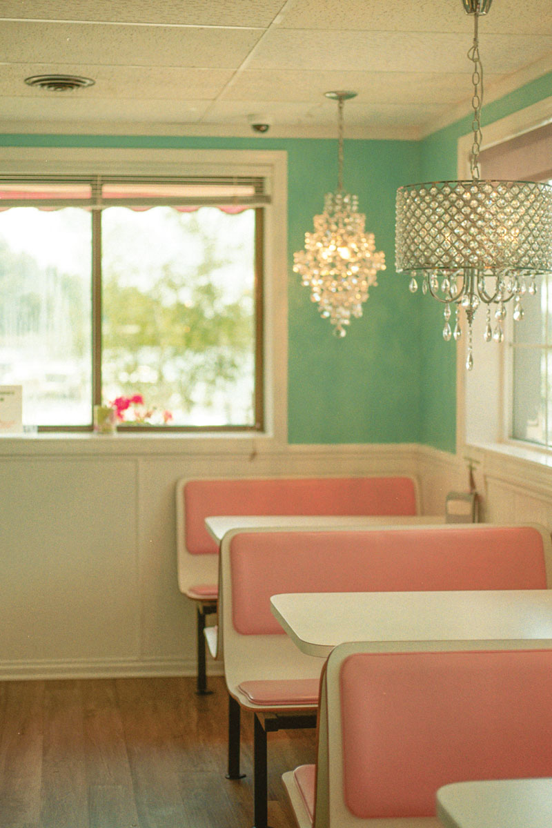 Pastel diner with pink booth and chandeliers