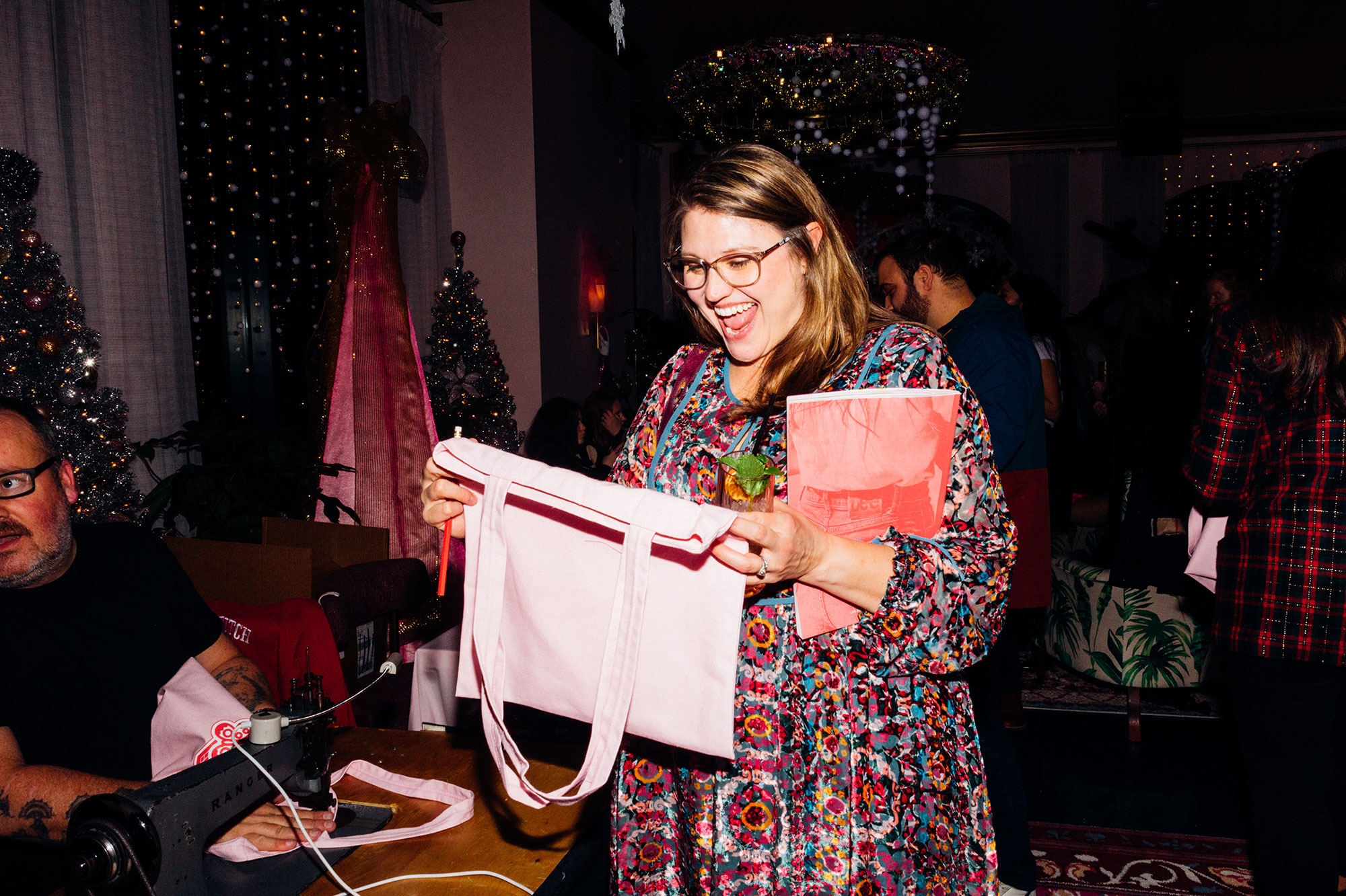 very happy woman with embriodered tote at the Dolly Parton Issue Release Party at Graduate Nashville