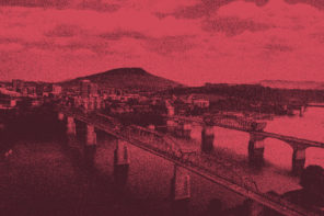 Aerial photo of Chattanooga, Tennessee. There are three bridges coming from a small town over a body or water. The picture has been edited with a dark pink colored overlay.