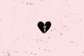 Black broken heart illustration on top of a light pink colored blacked covered with scattered black specks