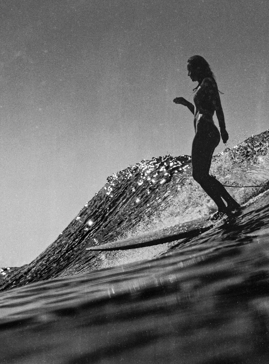 Black and white photo of a surfer on a crystal wave