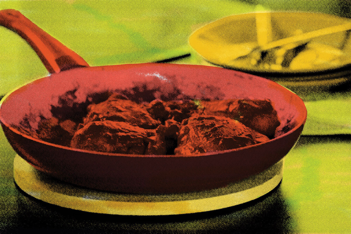 pan of Pollo Achiote on the table painted in bright green and red 
colors