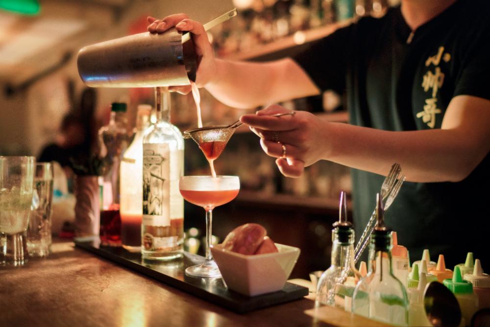 Bartender pouring craft cocktail