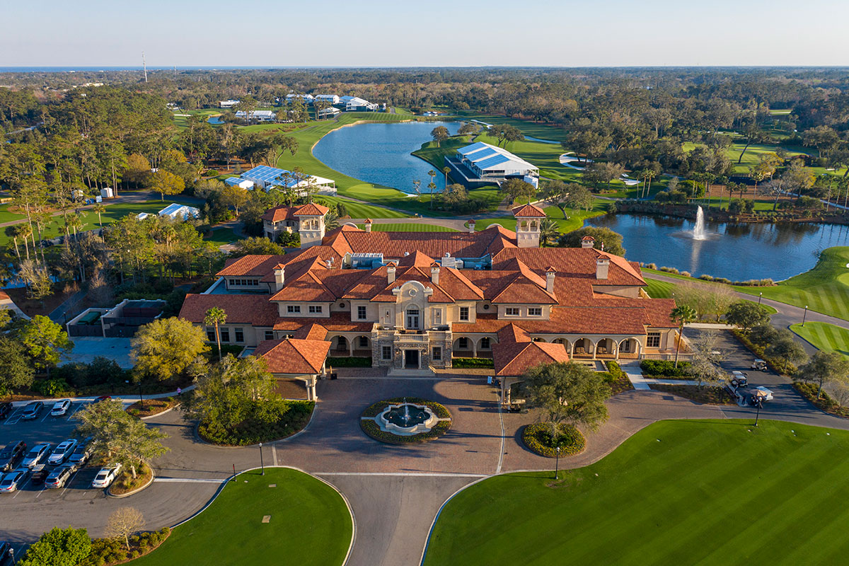 Aerial photo of the large orange clay roofed mansion and the lush light green golf course grounds of the Ponte Vedra Resort where The Players Championship takes place. There are 2 blue lakes on the grounds.