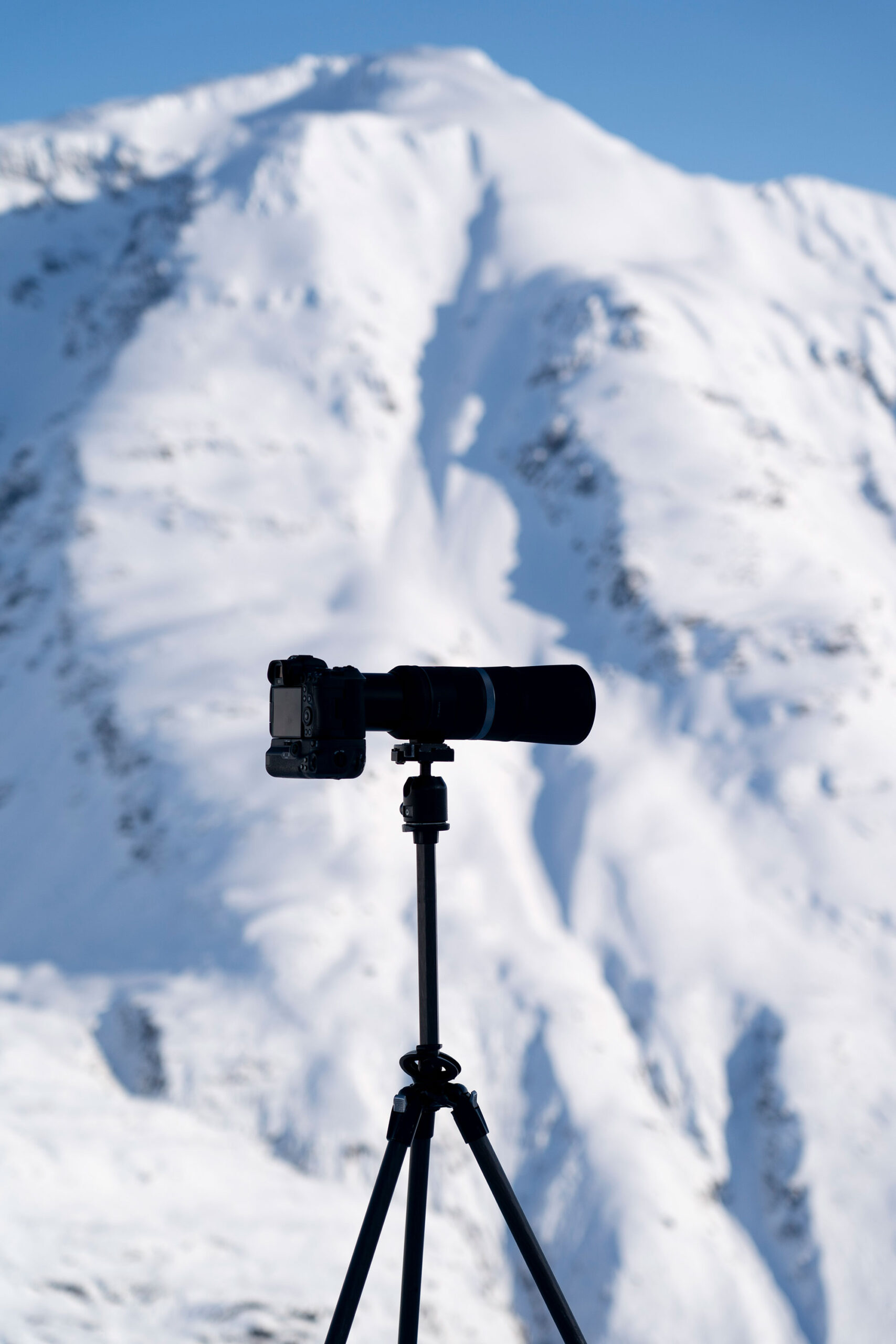 Camera on tripod with mountain in background