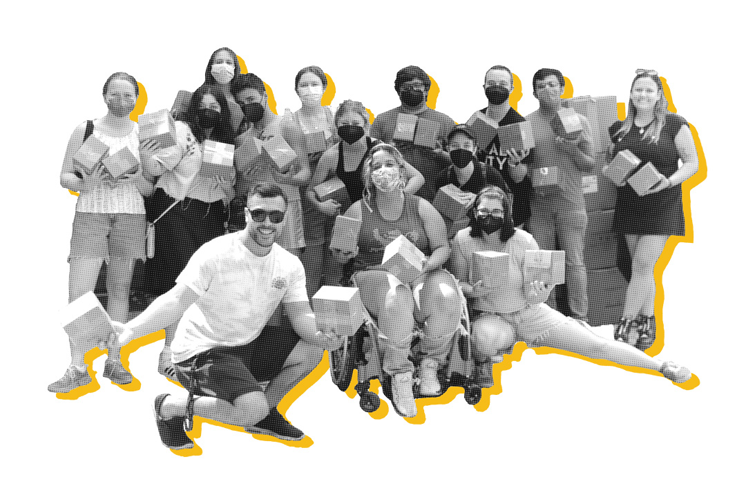 Cutout group photo of young adults posing for a picture holding small square boxes. Many of the people are standing for the photo but two are squatting in the front and one of the girls in the middle is sitting in a wheelchair. Many of the people are wearing face masks over their mouths. The photo is in black and white and has a yellow offset outline behind them. The photo also has a yellow offset outline behind it.