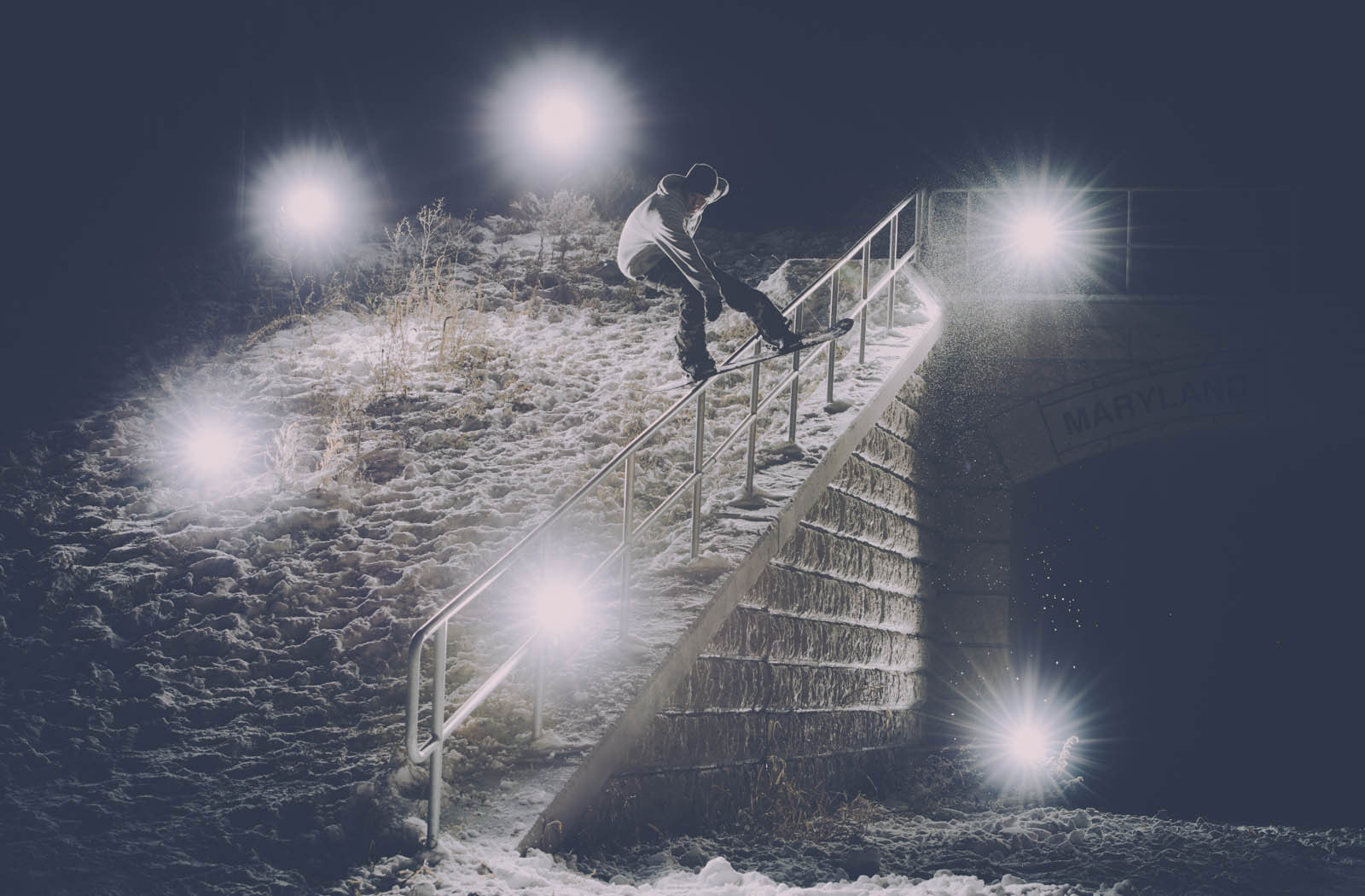 Person snowboarding down a railing
