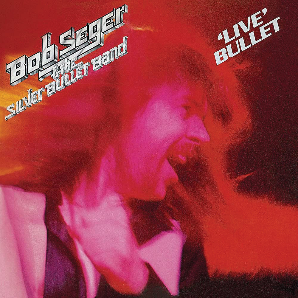 Album cover of 'Live' Bullet but Bob Seger. Fuchsia and Red image of a man's face with blurred hair and rockin' out.