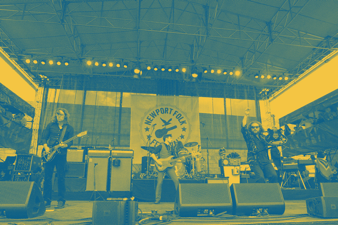 The band My Morning Jacket performing on stage at the Newport Folk Festival. The stage is filled with speakers, multiple microphones, a drum set, and other boxes. Front and center are three men playing electric guitars and the bass. Behind them the drummer is playing. To the sides of the stages are fans watching on. The photo has a blue and yellow duotone colored overlay and a halftone patterned texture on top.