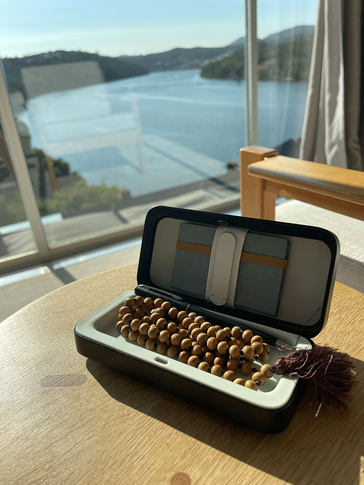A TROVA safe with meditation beads on a table