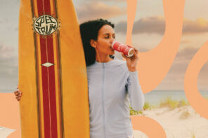 Girl with surfboard sipping Jeng cocktail on the beach with peach colored illustrated waves swirl around her.