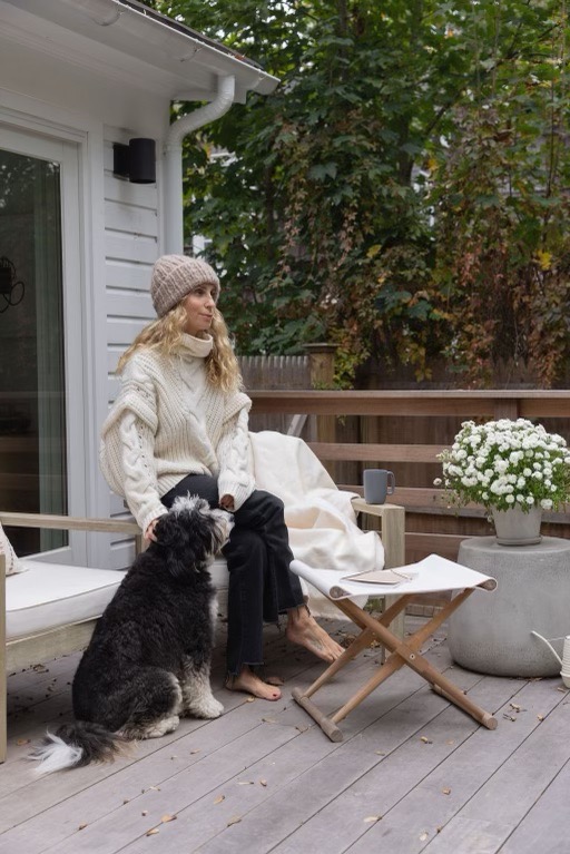 Laura Rubin with her dog sitting on the porch